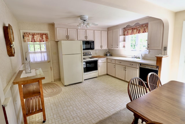 152 Cedar Ln, Middletown, CT 06457 - kitchen with white appliances, plenty of natural light, light countertops, and a sink