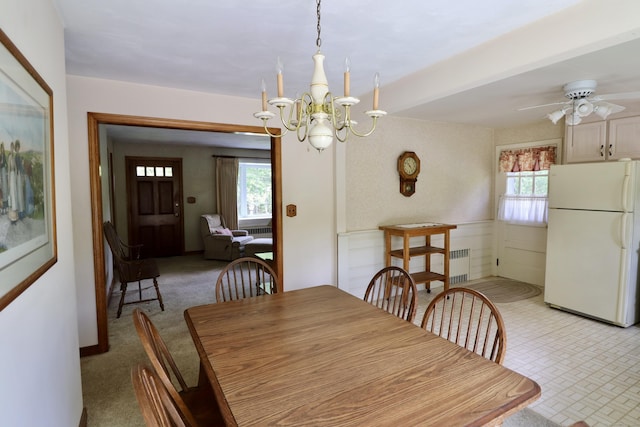 152 Cedar Ln, Middletown, CT 06457 - dining room with radiator heating unit, healthy amount of natural light, a chandelier, a ceiling fan, and a wainscoted wall