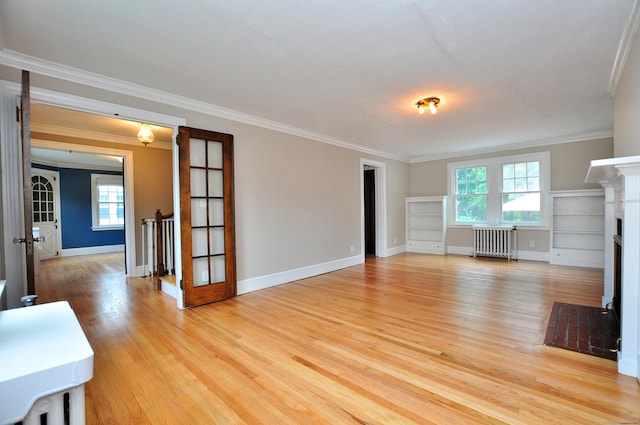 16 Ridgewood Rd, Windsor, CT 06095 - unfurnished living room with radiator, plenty of natural light, light wood-style flooring, crown molding, and a fireplace with flush hearth