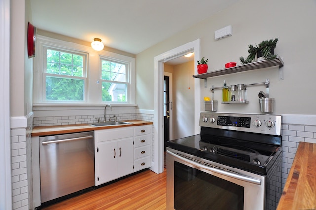 16 Ridgewood Rd, Windsor, CT 06095 - kitchen featuring stainless steel appliances, white cabinets, wood counters, decorative backsplash, and light wood-style flooring
