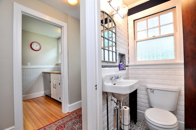 16 Ridgewood Rd, Windsor, CT 06095 - half bathroom with tile walls, wood finished floors, and wainscoting