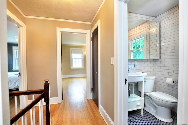 16 Ridgewood Rd, Windsor, CT 06095 - corridor with light wood-type flooring, ornamental molding, and tile walls