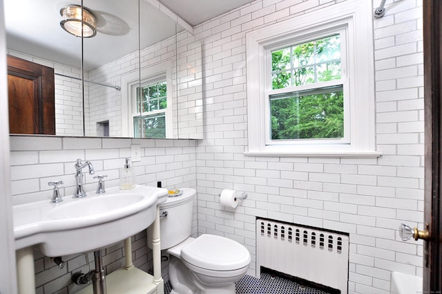 16 Ridgewood Rd, Windsor, CT 06095 - bathroom featuring radiator, tile walls, healthy amount of natural light, a shower, and tile patterned floors