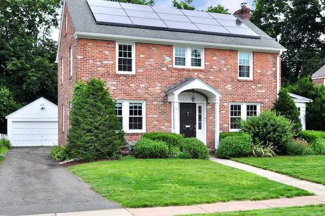 16 Ridgewood Rd, Windsor, CT 06095 - view of front of house featuring an outdoor structure, a front lawn, a garage, a shingled roof, and a chimney