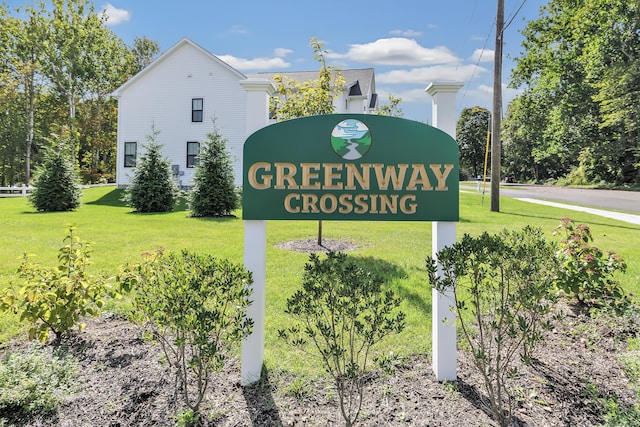 community / neighborhood sign with a yard