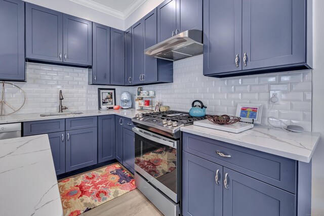 kitchen with under cabinet range hood, stainless steel range with gas stovetop, a sink, crown molding, and light stone counters