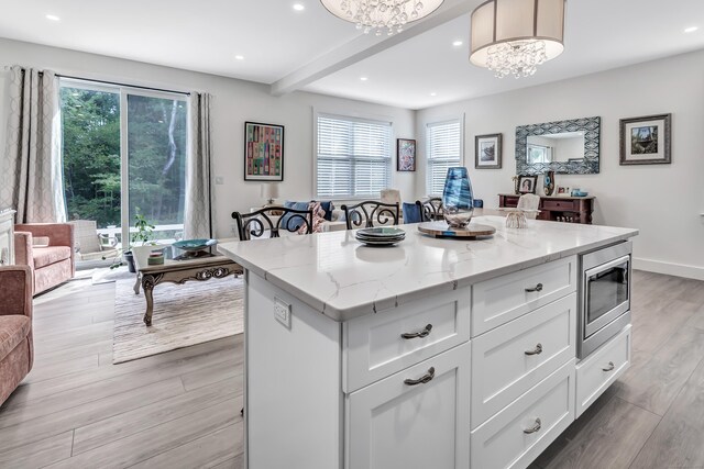 37 Old Rte 7 Unit 3, Brookfield, CT 06804 - kitchen with stainless steel microwave, a kitchen island, plenty of natural light, white cabinetry, and recessed lighting