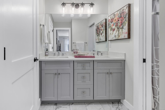 bathroom with marble look tiles, baseboards, and double vanity