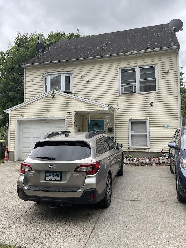 45 Ludlow St, Waterbury, CT 06710 - view of front of property featuring an attached garage, cooling unit, and driveway