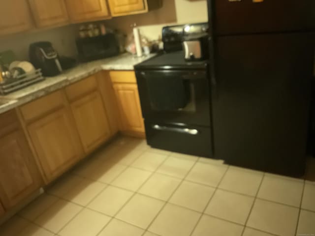 45 Ludlow St, Waterbury, CT 06710 - kitchen featuring light tile patterned floors and range
