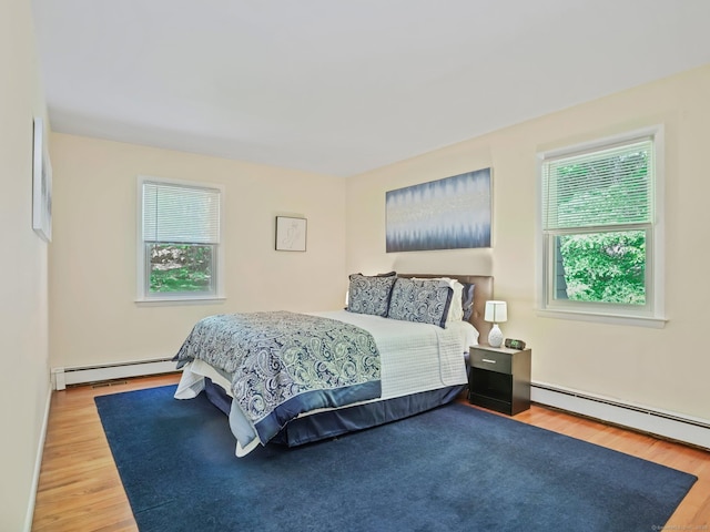 20 Mountain Wood Rd, Stamford, CT 06903 - bedroom with a baseboard heating unit, multiple windows, and wood finished floors