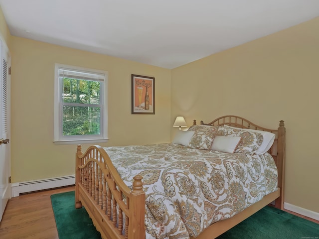 20 Mountain Wood Rd, Stamford, CT 06903 - bedroom featuring a baseboard radiator, wood finished floors, and baseboards