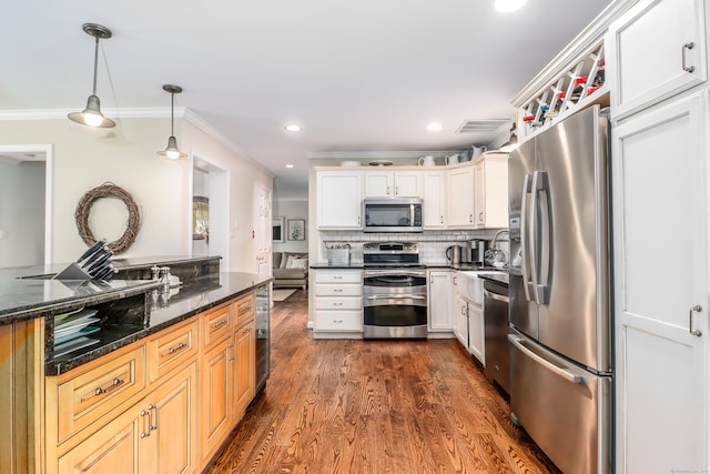 kitchen with appliances with stainless steel finishes, ornamental molding, decorative light fixtures, dark wood-style flooring, and decorative backsplash