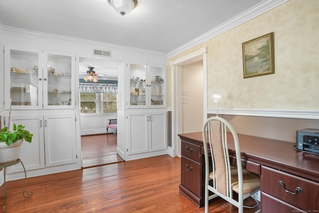 home office with wood finished floors, ceiling fan, and ornamental molding