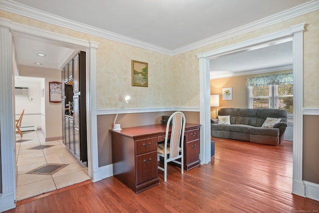 office space featuring a baseboard heating unit, wood finished floors, ornamental molding, and a wall mounted AC