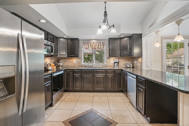 kitchen featuring appliances with stainless steel finishes, light tile patterned floors, plenty of natural light, a sink, and recessed lighting