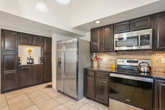 kitchen with appliances with stainless steel finishes, light tile patterned floors, backsplash, dark brown cabinets, and recessed lighting