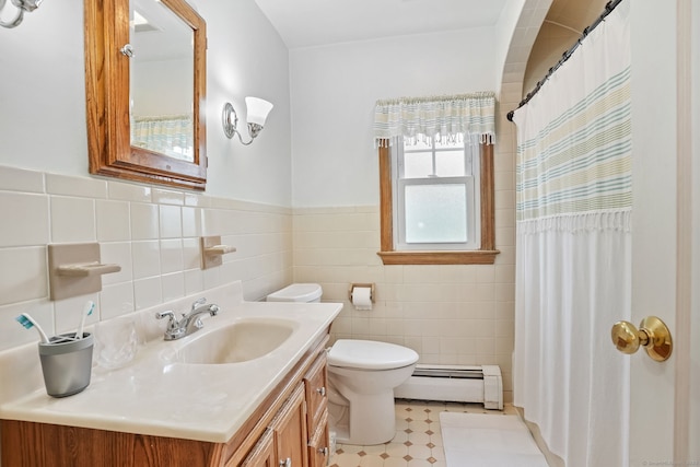 full bathroom featuring a baseboard radiator, tile walls, toilet, vanity, and wainscoting