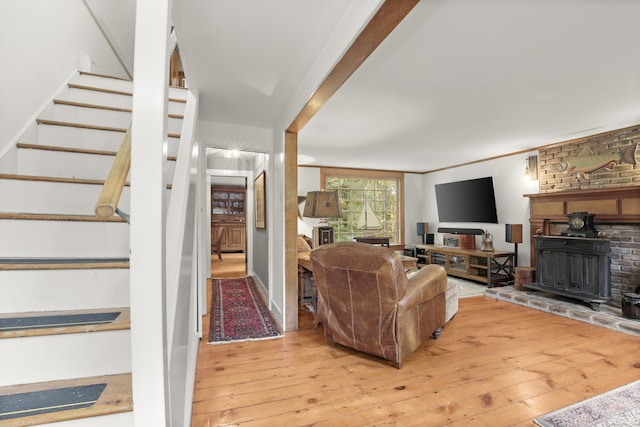 living area featuring wood-type flooring and stairway