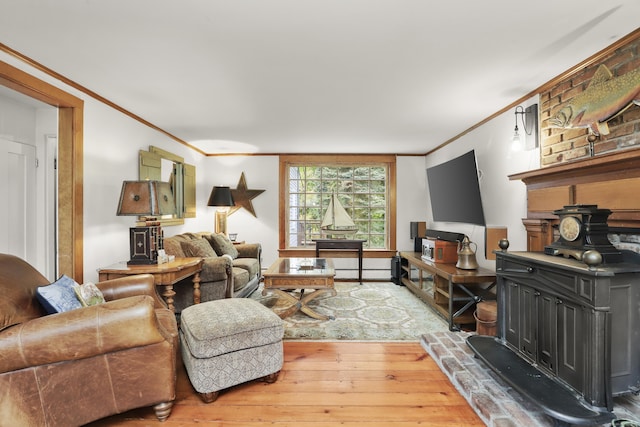 living area with ornamental molding, wood-type flooring, a wood stove, and baseboard heating