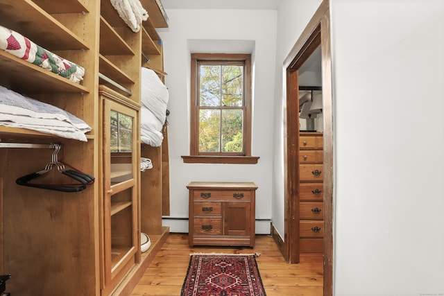 mudroom featuring light wood-type flooring, a baseboard heating unit, and a baseboard radiator