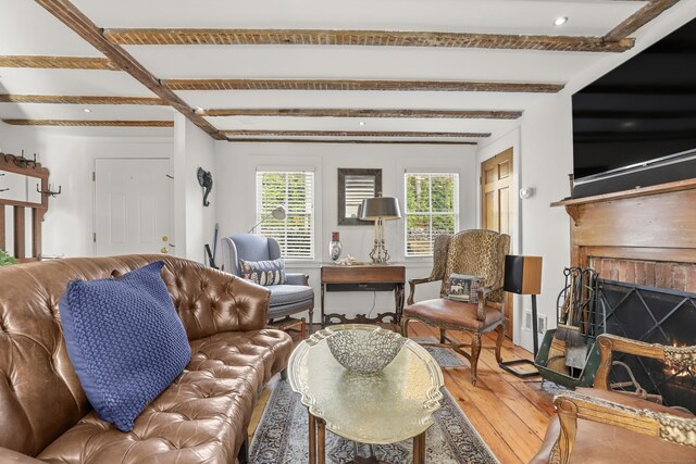 living room with hardwood / wood-style flooring, healthy amount of natural light, beamed ceiling, a fireplace, and recessed lighting