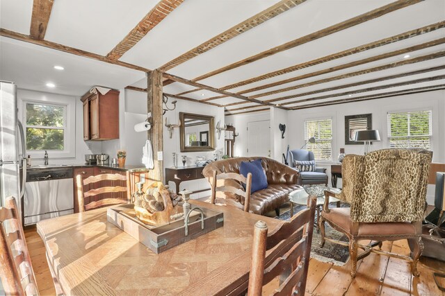 dining space featuring hardwood / wood-style flooring, beam ceiling, and recessed lighting