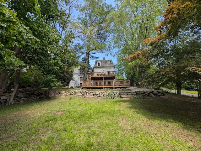 view of grassy yard with a deck