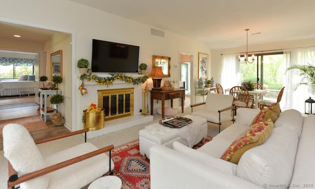 living room with a chandelier, a fireplace, and recessed lighting