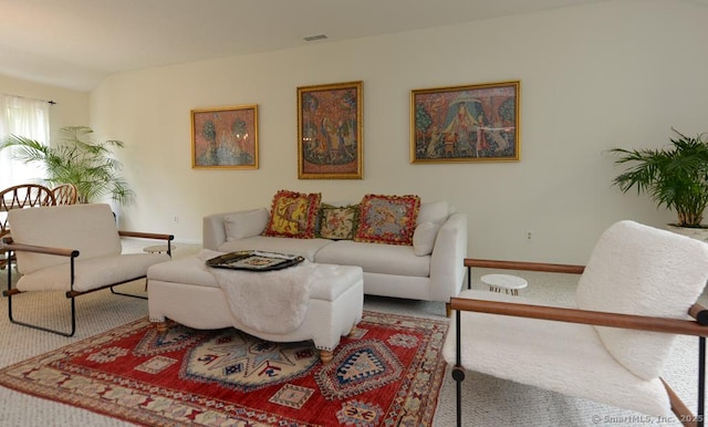 living area featuring carpet floors and baseboards