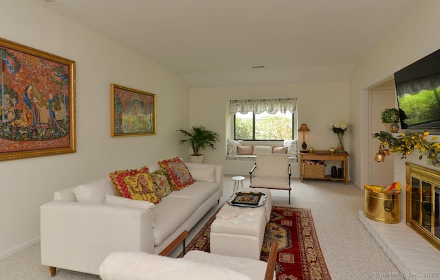 living room featuring carpet flooring and a brick fireplace