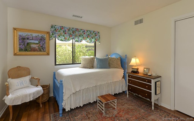 bedroom featuring wood finished floors and baseboards