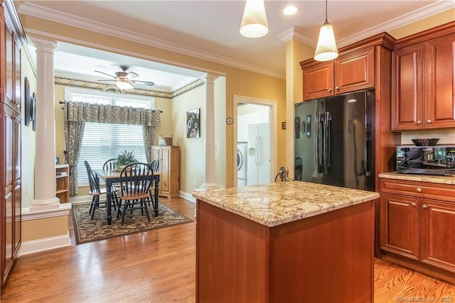2 Crestview Dr Unit 2, Middlefield, CT 06481 - kitchen with ornate columns, freestanding refrigerator, washer / dryer, crown molding, and light stone countertops