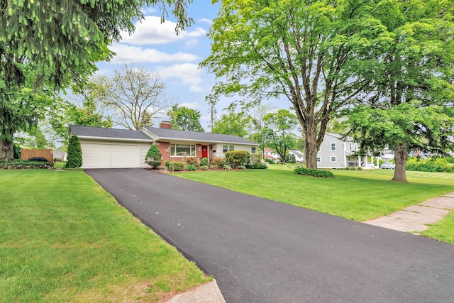 26 Williams Rd, Cheshire, CT 06410 - view of front facade featuring a garage, asphalt driveway, a chimney, a front yard, and brick siding