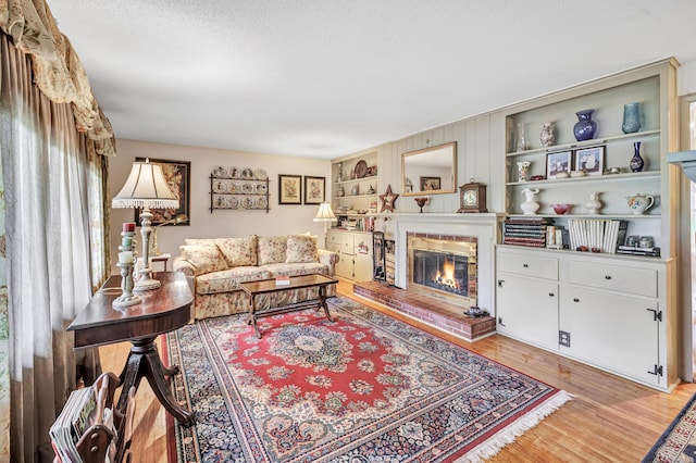 26 Williams Rd, Cheshire, CT 06410 - living area featuring a fireplace, light wood-type flooring, and a textured ceiling