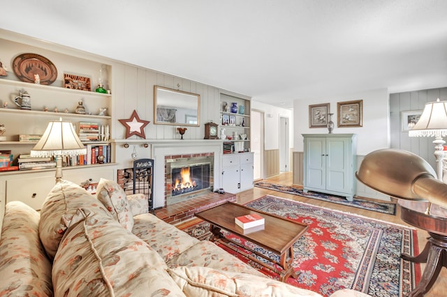 26 Williams Rd, Cheshire, CT 06410 - living room featuring a brick fireplace, wood finished floors, and built in shelves