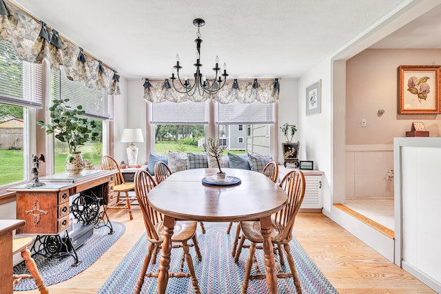 26 Williams Rd, Cheshire, CT 06410 - dining room featuring light wood-style flooring, healthy amount of natural light, a chandelier, and wainscoting