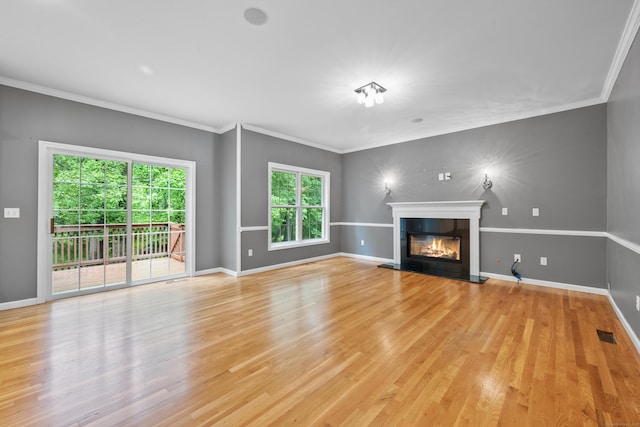 65 Macarthur Ln Apt 6, Stamford, CT 06902 - unfurnished living room featuring a glass covered fireplace, light wood-style floors, ornamental molding, and baseboards