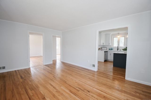 5 Roberge Rd, Bristol, CT 06010 - unfurnished living room featuring ornamental molding, light wood-style floors, a sink, and baseboards