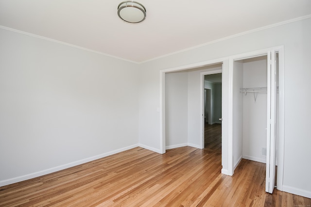 5 Roberge Rd, Bristol, CT 06010 - unfurnished bedroom with crown molding, baseboards, light wood-type flooring, and a closet