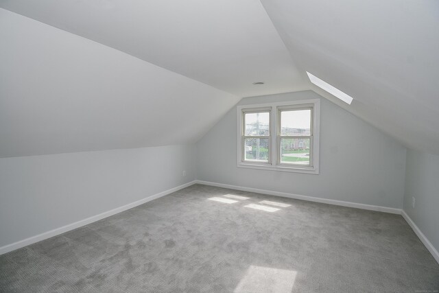 5 Roberge Rd, Bristol, CT 06010 - additional living space with carpet floors, vaulted ceiling, baseboards, and a skylight