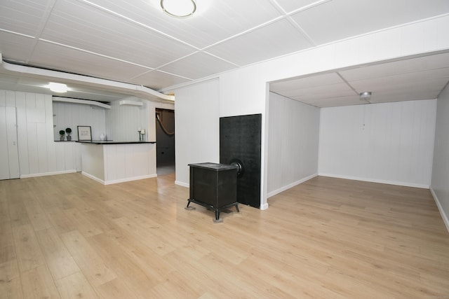 5 Roberge Rd, Bristol, CT 06010 - finished basement featuring light wood-style floors, baseboards, and a wood stove