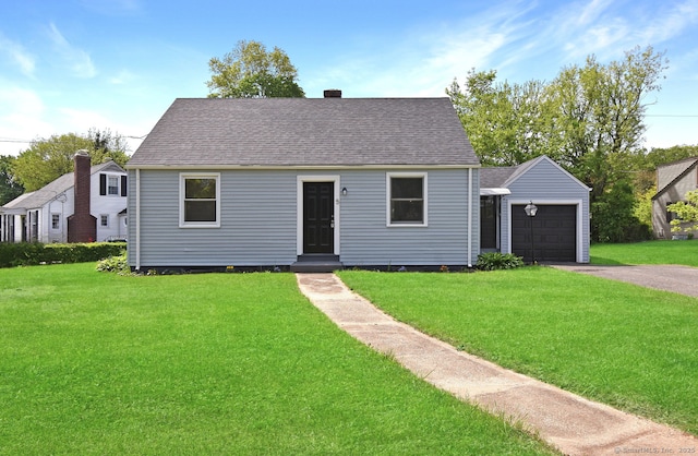 5 Roberge Rd, Bristol, CT 06010 - new england style home featuring a garage, asphalt driveway, a front lawn, and an outdoor structure