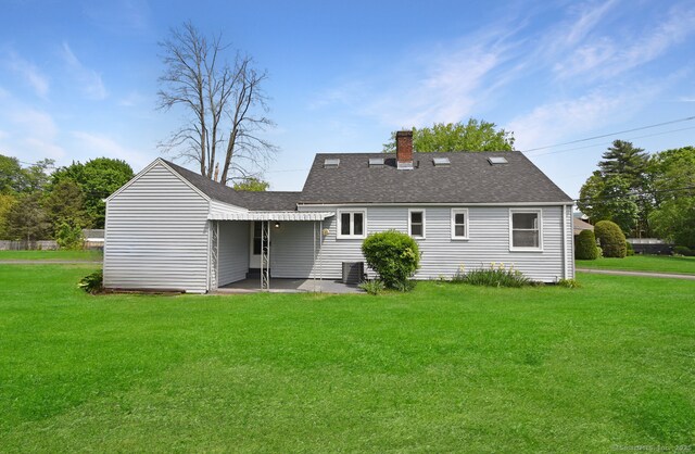 5 Roberge Rd, Bristol, CT 06010 - back of house with central air condition unit, a chimney, a lawn, and a patio area