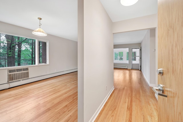 42 N Lake Dr Apt C2, Hamden, CT 06517 - corridor featuring wood finished floors, a baseboard heating unit, baseboard heating, and baseboards
