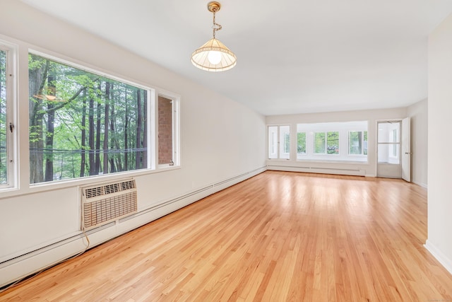 42 N Lake Dr Apt C2, Hamden, CT 06517 - empty room featuring wood finished floors, a baseboard radiator, baseboards, and a wall mounted air conditioner