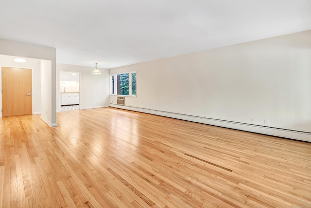 42 N Lake Dr Apt C2, Hamden, CT 06517 - unfurnished living room featuring a baseboard radiator, light wood-style flooring, and baseboards