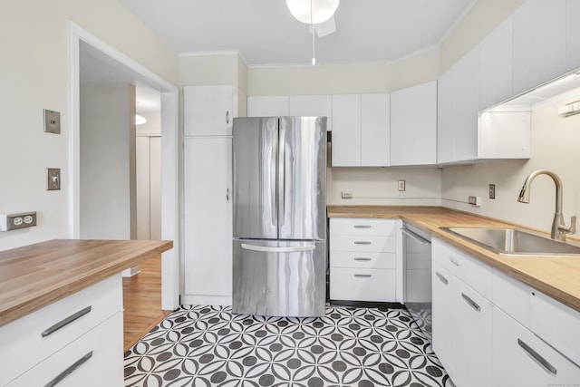 42 N Lake Dr Apt C2, Hamden, CT 06517 - kitchen featuring appliances with stainless steel finishes, a sink, wood counters, white cabinets, and ornamental molding