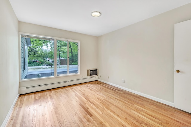 42 N Lake Dr Apt C2, Hamden, CT 06517 - unfurnished room featuring a baseboard heating unit, hardwood / wood-style floors, baseboards, and an AC wall unit