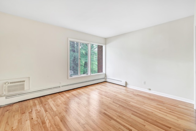 42 N Lake Dr Apt C2, Hamden, CT 06517 - spare room featuring baseboard heating, light wood-type flooring, and baseboards